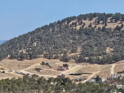 an aerial view of a mountain with houses on it at Sorjat Al Tal Chalet in Umm Tall