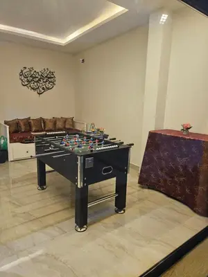 a room with a giant chess table in the middle at Sorjat Al Tal Chalet in Umm Tall