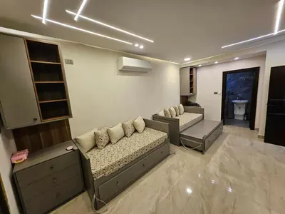 a living room with two couches at Sorjat Al Tal Chalet in Umm Tall