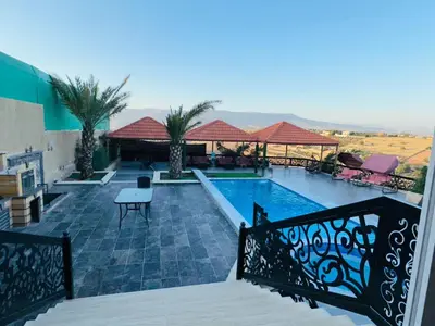 a view of a swimming pool from a balcony at The Royal Chalet in Ath Thukhaynāt