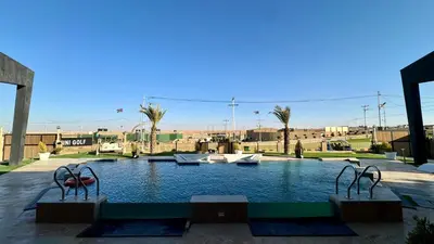 a swimming pool with two metal sculptures in it at Giving City in Amman