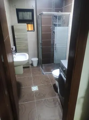 a bathroom with a toilet and a sink and a shower at Amman in Amman
