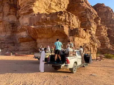 a group of people riding in the back of a truck at Wahj Ram camp in Aqaba