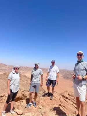 a group of men standing on a rock in the desert at Wahj Ram camp in Aqaba