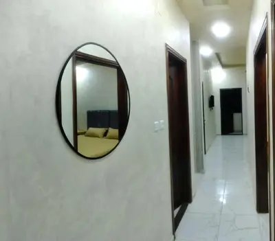 a mirror hanging on a wall in a hallway at Ayla Furnished Apartments in Aqaba