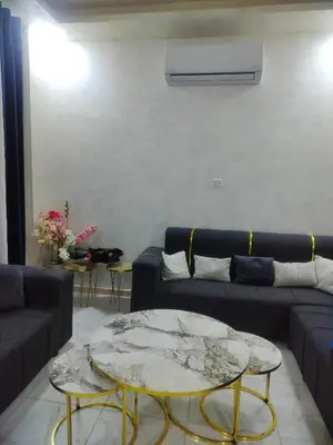 a living room with a couch and a table at Ayla Furnished Apartments in Aqaba