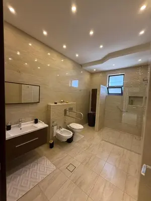 a bathroom with a sink and a toilet and a shower at Dabouq 3BR condo in Amman