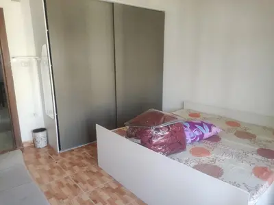 a kitchen with a refrigerator and a counter top at الدوار السابع in Amman