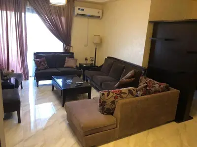 a living room with a couch and a table at Apartment in the heart of Amman in Amman