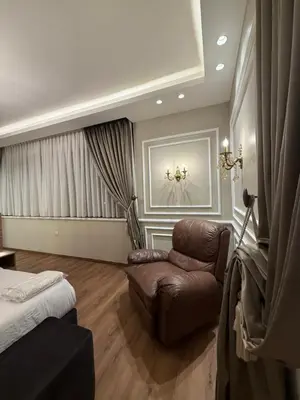 a living room with a couch and a bed at amazing rooftop-studio at abdoun 702 in Amman