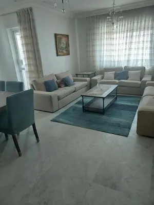 a living room with couches and a coffee table at Dream Home furnished Apartment in Amman