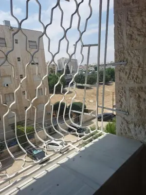 a metal fence in front of a building at Dream Home furnished Apartment in Amman