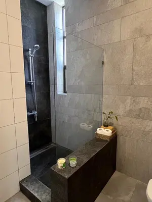 a bathroom with a shower and a sink at Newly refurbished 2-bedroom flat in a compound in Amman