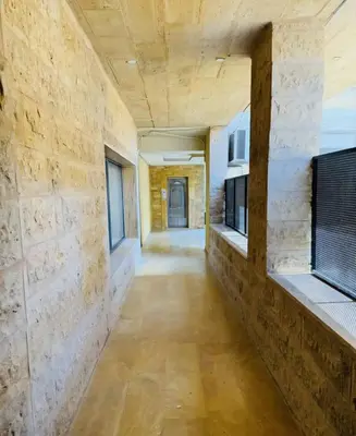 a hallway in a room with stone walls at Swemeh hills resort in Sowayma