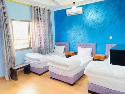 a room with two beds and two chairs at 2bedroom apartment with balcony in Aqaba