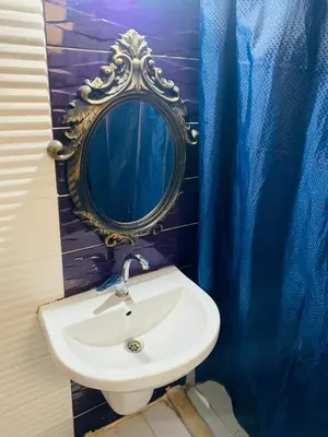 a bathroom with a sink and a mirror at 2bedroom apartment with balcony in Aqaba