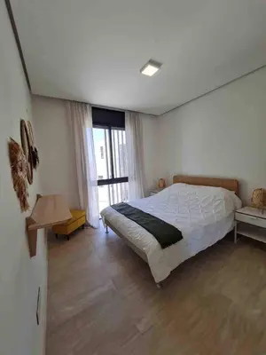 a bedroom with a bed and a large window at Brand new modern apartment in Ayla Golf residence in Aqaba