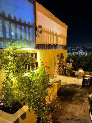 a yellow building with flowers in front of it at شاليه بانا جرش in Jerash