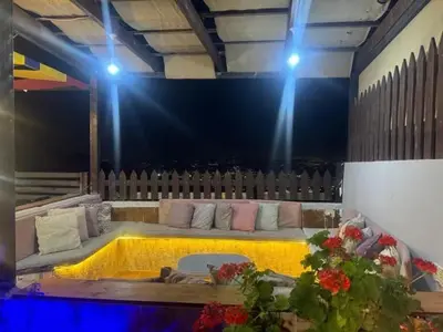 a stage with a couch in a room with lights at شاليه بانا جرش jerash