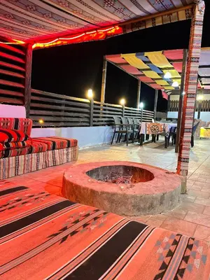 a stage with chairs and a fire pit in the middle at شاليه بانا جرش jerash