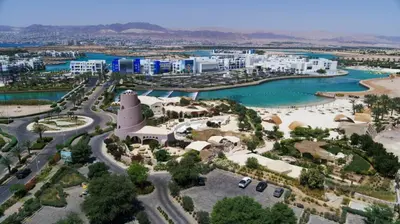 an aerial view of a city with a beach and buildings at Cozy Apartment with Private Beach, couples and families only in Aqaba