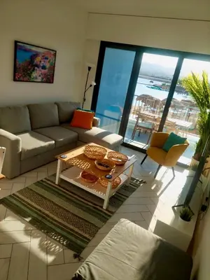 a living room with a couch and a table at Cozy Apartment with Private Beach, couples and families only in Aqaba