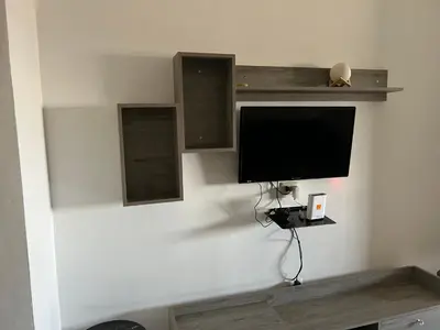 a flat screen tv on a white wall at Murjan in Amman
