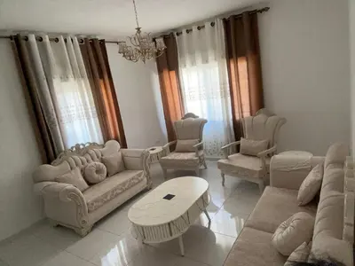a living room with couches and chairs and a table at Murjan in Amman