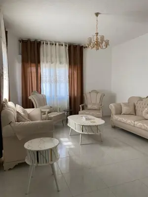 a living room with two tables and two couches at Murjan in Amman