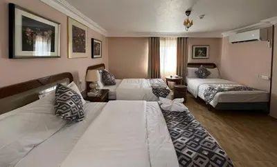 a hotel room with two beds and a window at Mass Plaza Hotel in Aqaba