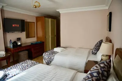 a hotel room with two beds and a television at Mass Plaza Hotel in Aqaba