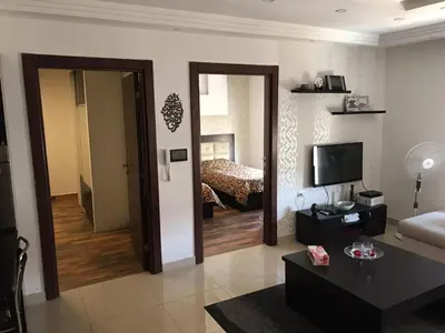 a living room with a couch and a bed at Peaceful apartment in Amman 7th Circle near Cozmo in Amman