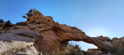 an arch in the rocks on a mountain at Tafila-Mataan in Al Jafr