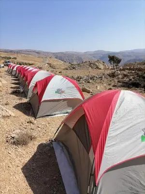 a row of tents sitting on top of a hill at Tafila-Mataan in Al Jafr