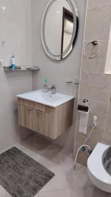 a bathroom with a sink and a mirror at شقة واسعة مع ترس كبير in Amman