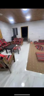 a room with a bunch of chairs and a table at Moose house in Ajloun