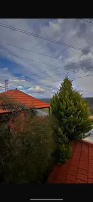 a house with a red roof and a tree at Moose house in Ajloun
