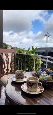 two cups of coffee on a table on a balcony at Moose house in Ajloun
