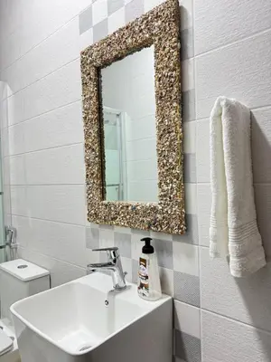 a bathroom with a sink and a mirror on the wall at Modern Apartment in Prime Location - Jabal Amman in Amman