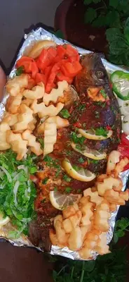 a plate of food with meat and vegetables on it at يرموك هاوس in Aş Şarīḩ