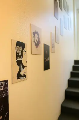 a wall with pictures hanging on a wall at Beit Ahlam Quiet Duplex Villa with Terrace and Scenic View near Umm Qais Ruins in Um Qeis