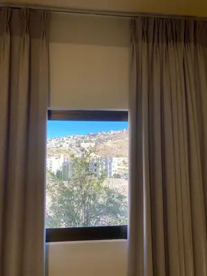 a window with a view of a city at Petra Jewel Hotel in Wadi Musa