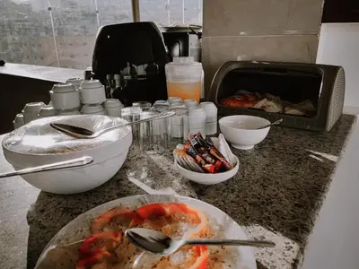 a kitchen counter with a plate of food on a table at Petra Jewel Hotel in Wadi Musa