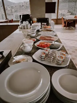 a long table with plates of food on it at Petra Jewel Hotel in Wadi Musa