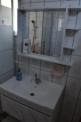 a bathroom with a sink and a mirror at Furnished Apartment شقة مفروشة in Irbid