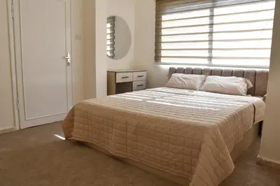 a bedroom with a large bed with a window at Furnished Apartment شقة مفروشة in Irbid