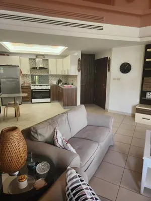 a living room with a couch and a kitchen at 4th circle embassy district 2 bedrooms الدوار الرابع حي السفارات in Amman