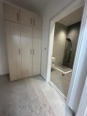 a bathroom with a walk in shower and a treadmill at Hassan