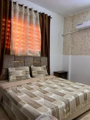 a bedroom with a large bed and a window at دار زمان Zaman Suites Old Town in Al Mafraq