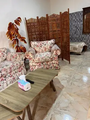 a living room with two couches and a coffee table at دار زمان Zaman Suites Old Town in Al Mafraq